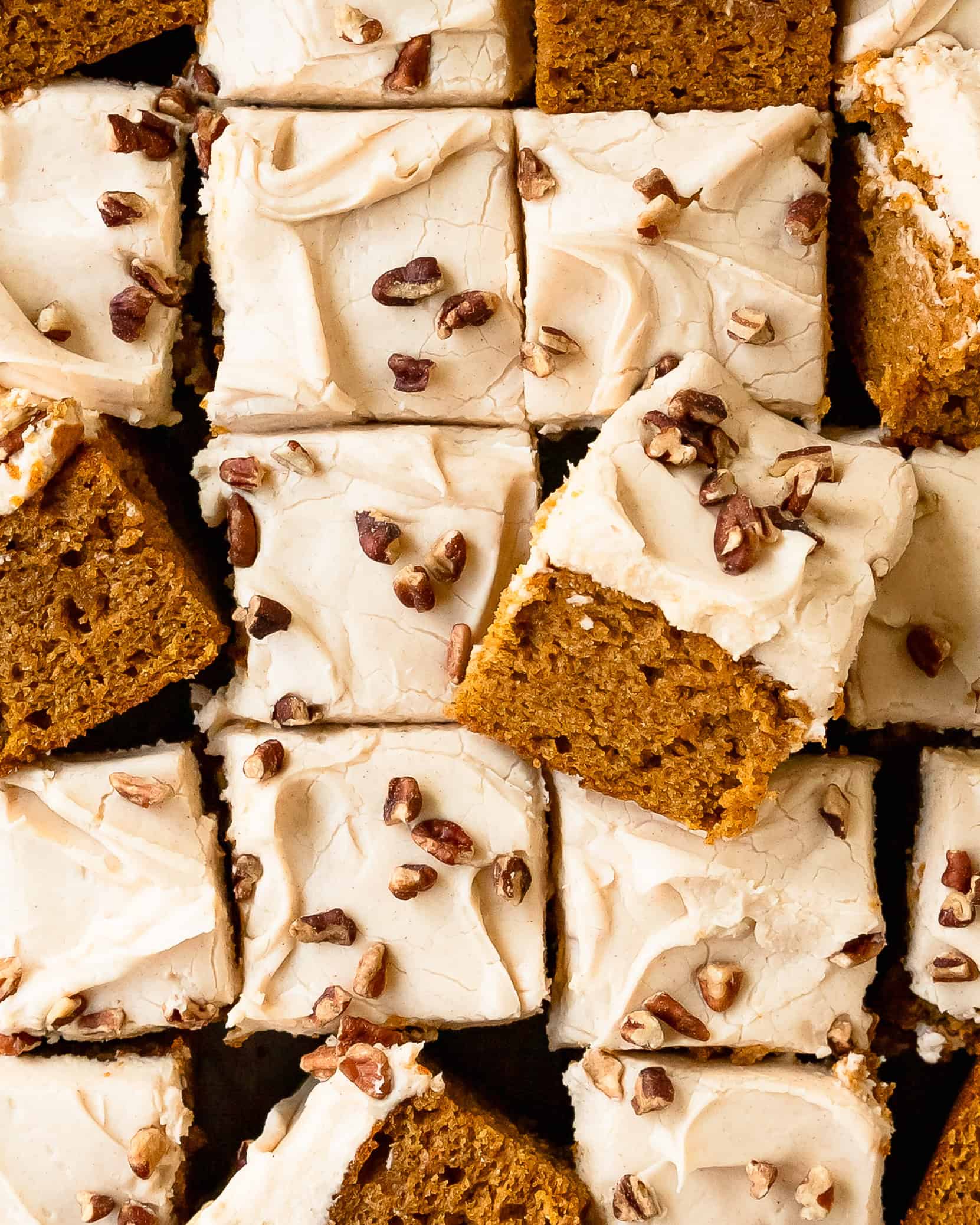 Sweet potato cake topped with thick cream cheese frosting and chopped pecans.