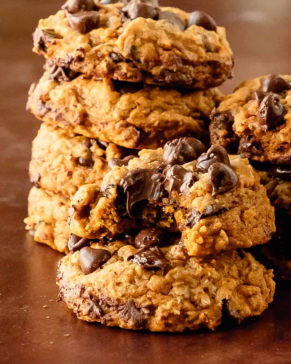 Stack of sweet potato cookies showing soft and chewy inside with lots of melty chocolate chips.