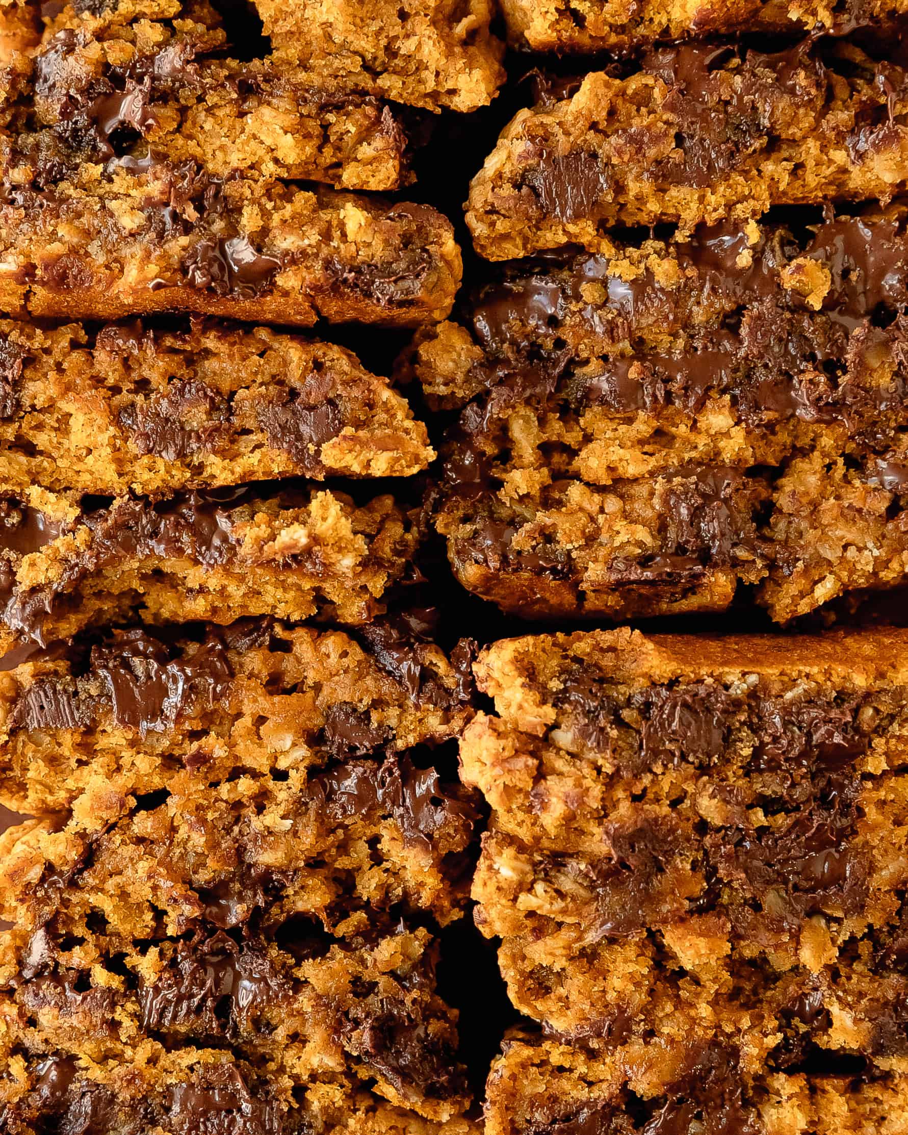 Slices of sweet potato cookies showing inside with chewy centers and melty chocolate chips.